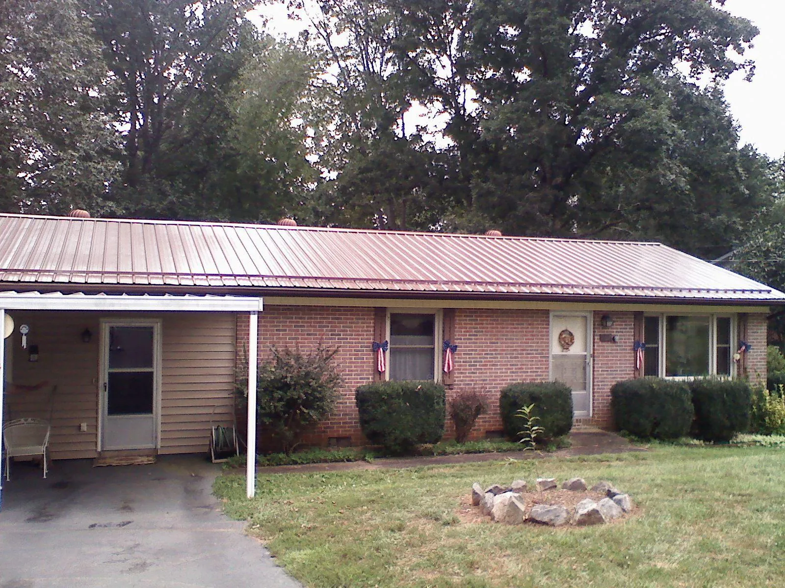 Bronze metal roof and carport on a brick ranch home — Roof Repair work by our crew in Center Valley