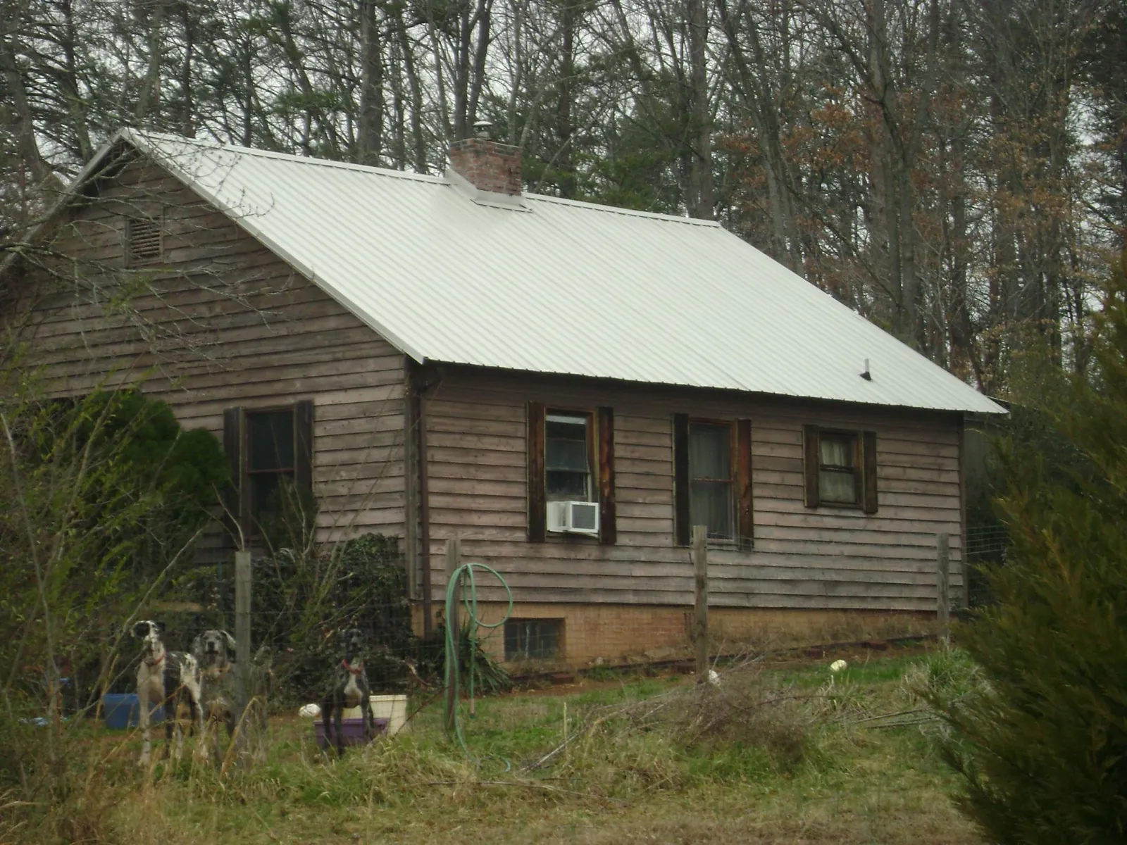 White metal roof on an old wood sided farmhouse, from a Metal Roof Installation job in Center Valley